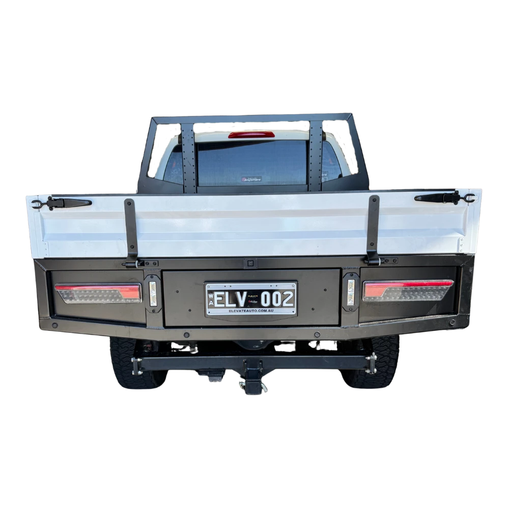 Back view of a truck with a flatbed and license plate on a white background – Dual Cab 1800mm Aluminium Tray with 1m Trundle Drawer 50L Water tank & Colour Coded Tray Sides