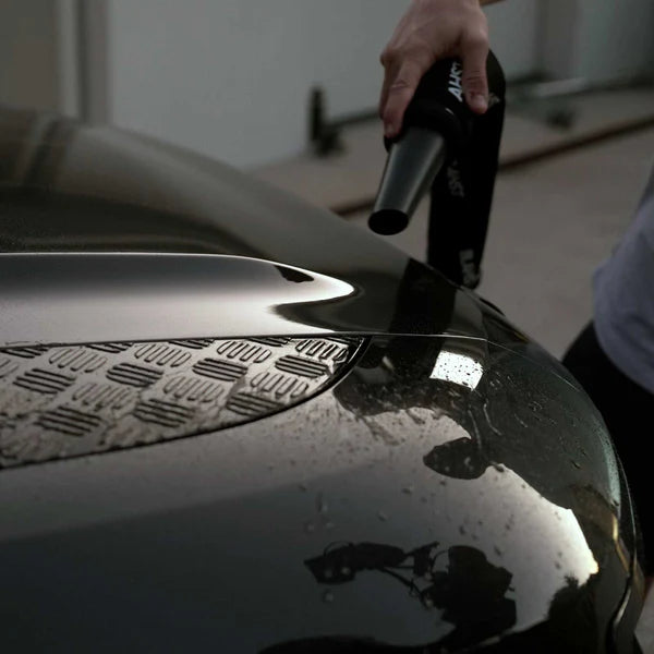 Person using a Air Maxx Dryer on a car's hood