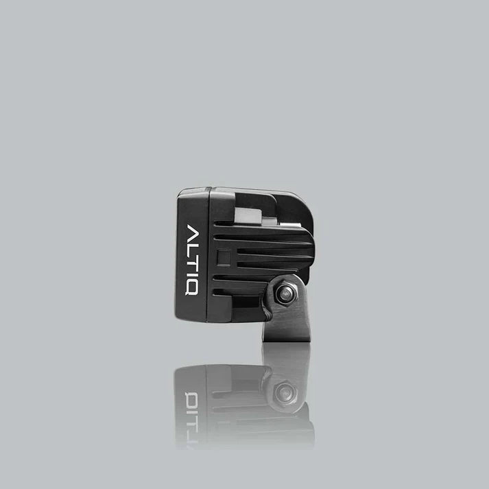 ALTIQ CX4 work light seen from the side, the ribbed black housing with the ALTIQ name down the face and the stainless mounting bracket below