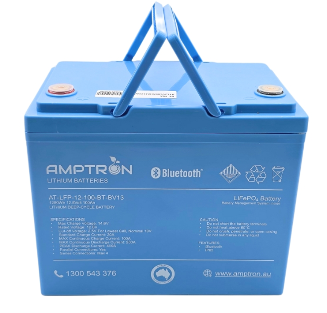 Amptron AT-LFP-12-100-BT-BV13 battery face on with the carry handle raised, the label listing 1280Wh, 12.8 volts, 100Ah, max charge voltage 14.6V, standard charge current 20A, max continuous charge 100A, max continuous discharge 200A, peak discharge 400A, parallel connections yes and series connections up to four