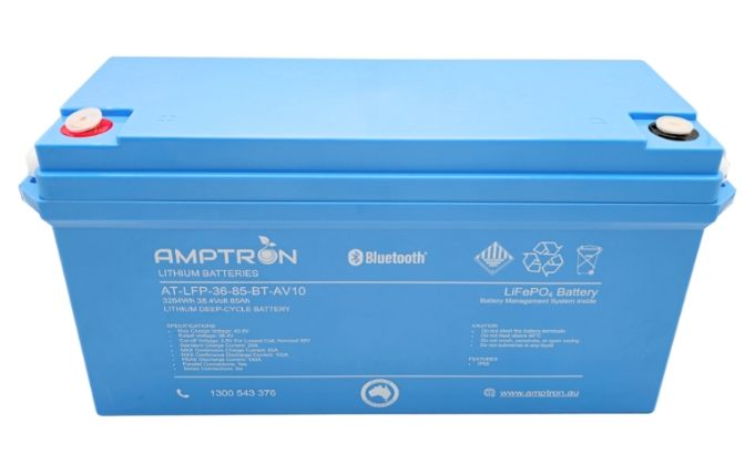 Amptron AT-LFP-36-85-BT-AV10 lithium battery face on, the blue case labelled 3264Wh 38.4 volt 85Ah lithium deep-cycle battery with Bluetooth, LiFePO4 and battery management system inside, the specification and caution panels below, and the red and black terminal covers on top