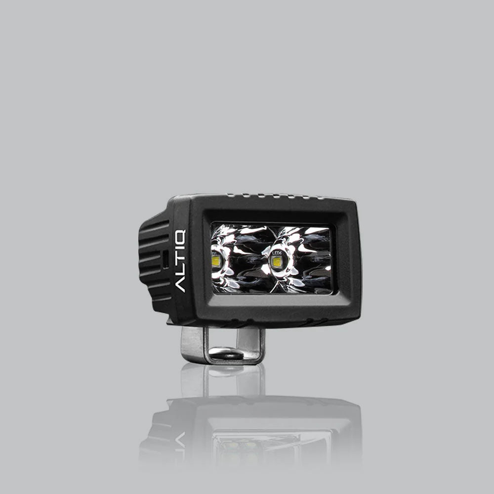 ALTIQ CX2 spot work light face on, a rectangular reflector holding two deep spot optics with a single LED in each, the ALTIQ name on the left cheek
