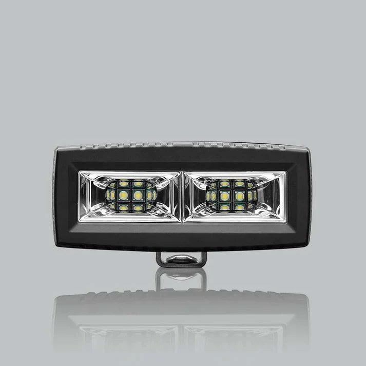 ALTIQ CX4 scene work light square on, a wide rectangular lens holding two reflector segments each with a dense cluster of LEDs, in a black housing with the mounting bracket beneath