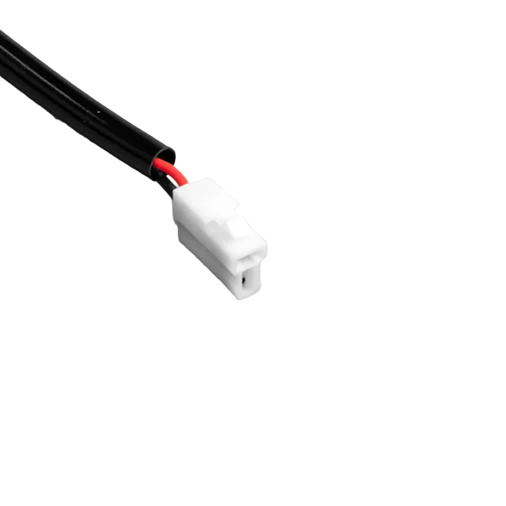 Close-up of the white two-pin plug on the halogen piggy-back adaptor, red and black wires entering the moulded body from the black sheathed lead