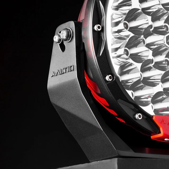 The Rogue mounting bracket from the side, lit in red, showing the pivot bolt at the top, the ALTIQ name down the arm and the reflector face alongside