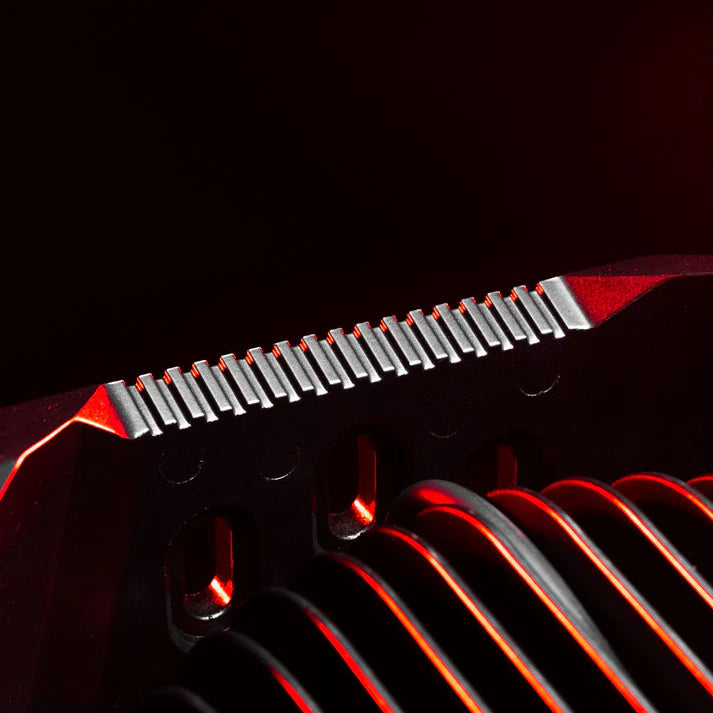 Detail of the Rogue housing lit in red, the machined comb of cooling fins along the top edge above the cast heatsink ribs