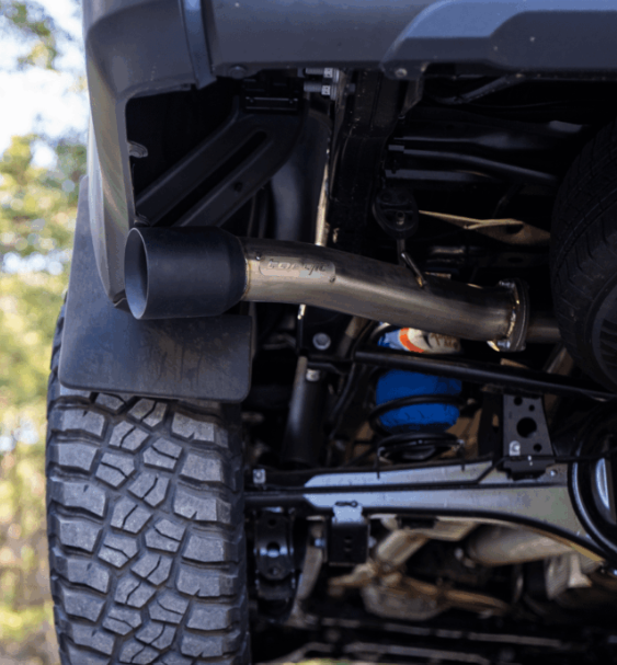 Close-up of a vehicle's exhaust system with a muffler and pipe