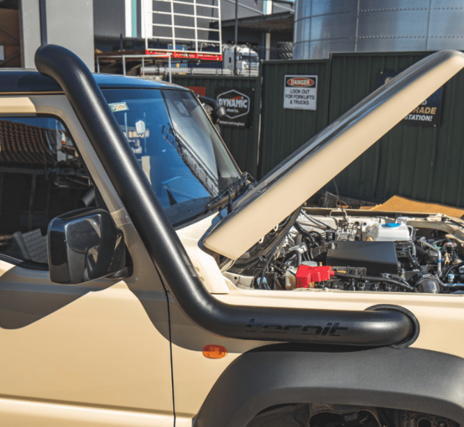 Beige off-road vehicle with a black roll bar in an outdoor setting