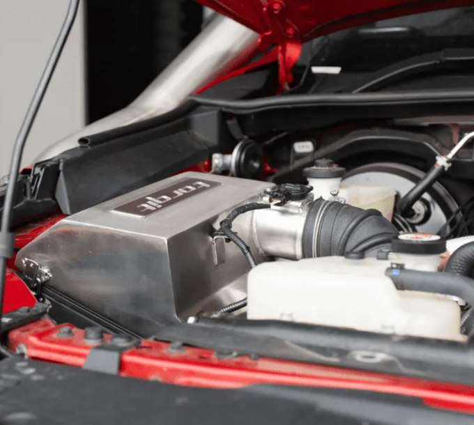 Close-up of a car engine with visible branding