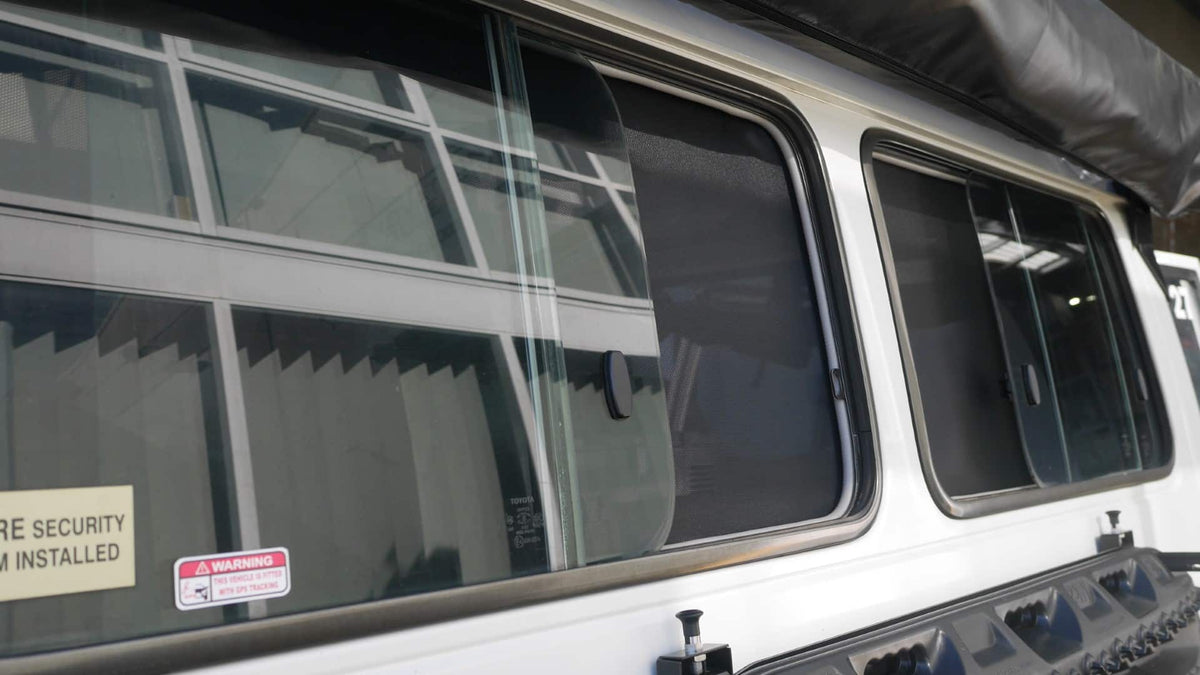 Close-up of a vehicle window with security stickers on a white background