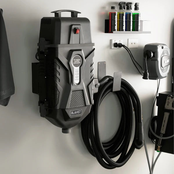 Wall-mounted Blahst K21 Vacuum in a garage setting