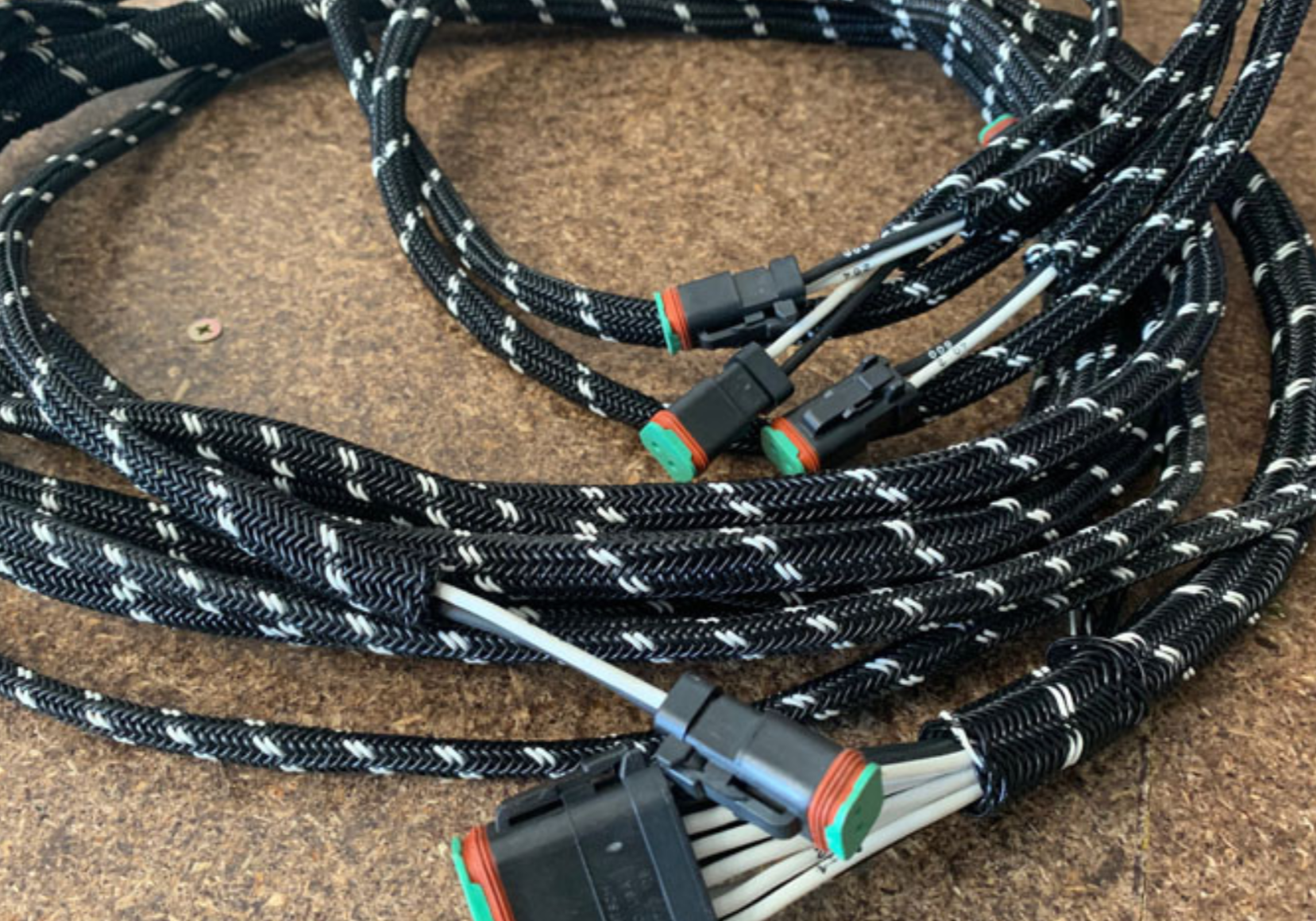 Coiled cable with connectors on a textured surface