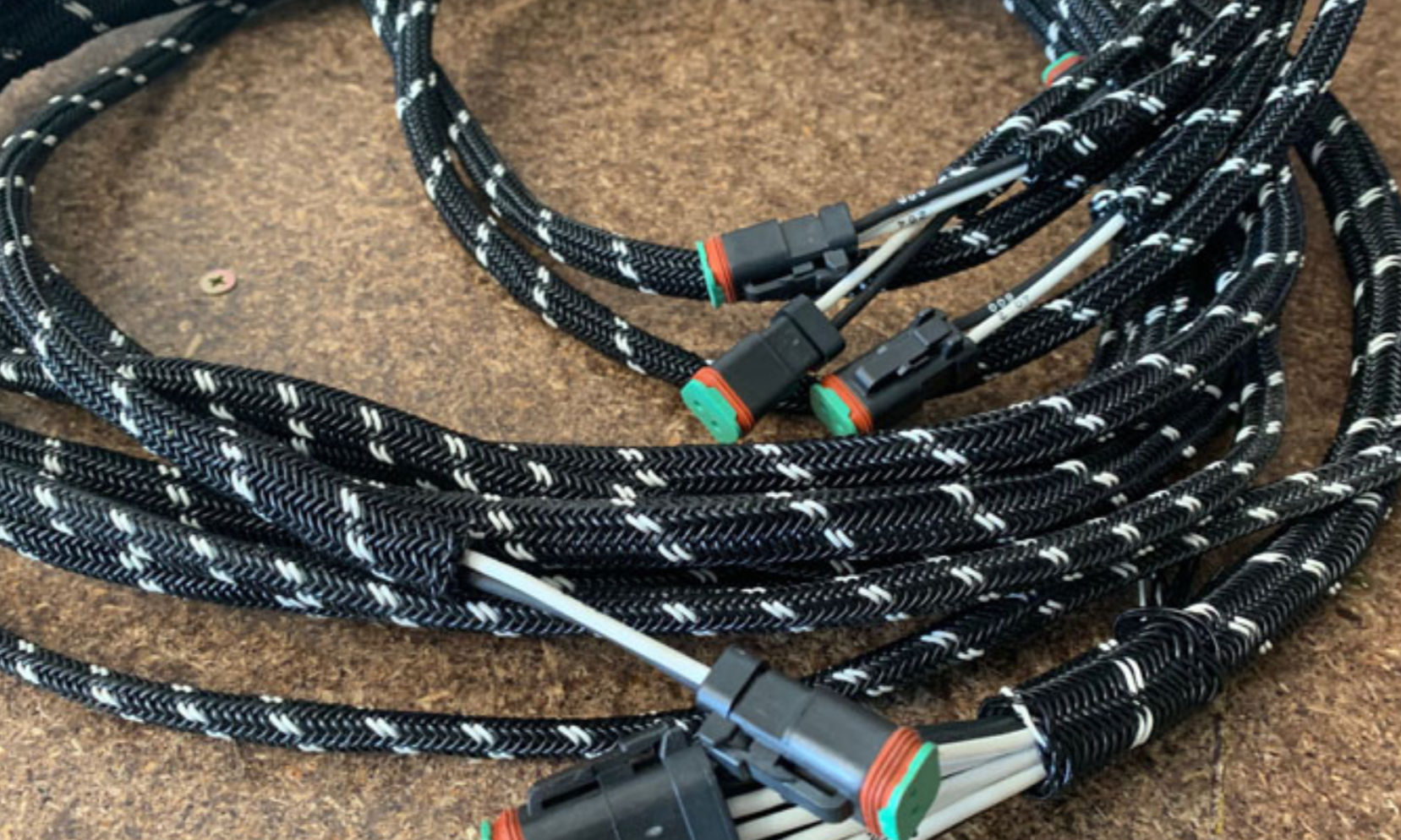 Coiled cable with connectors on a textured surface