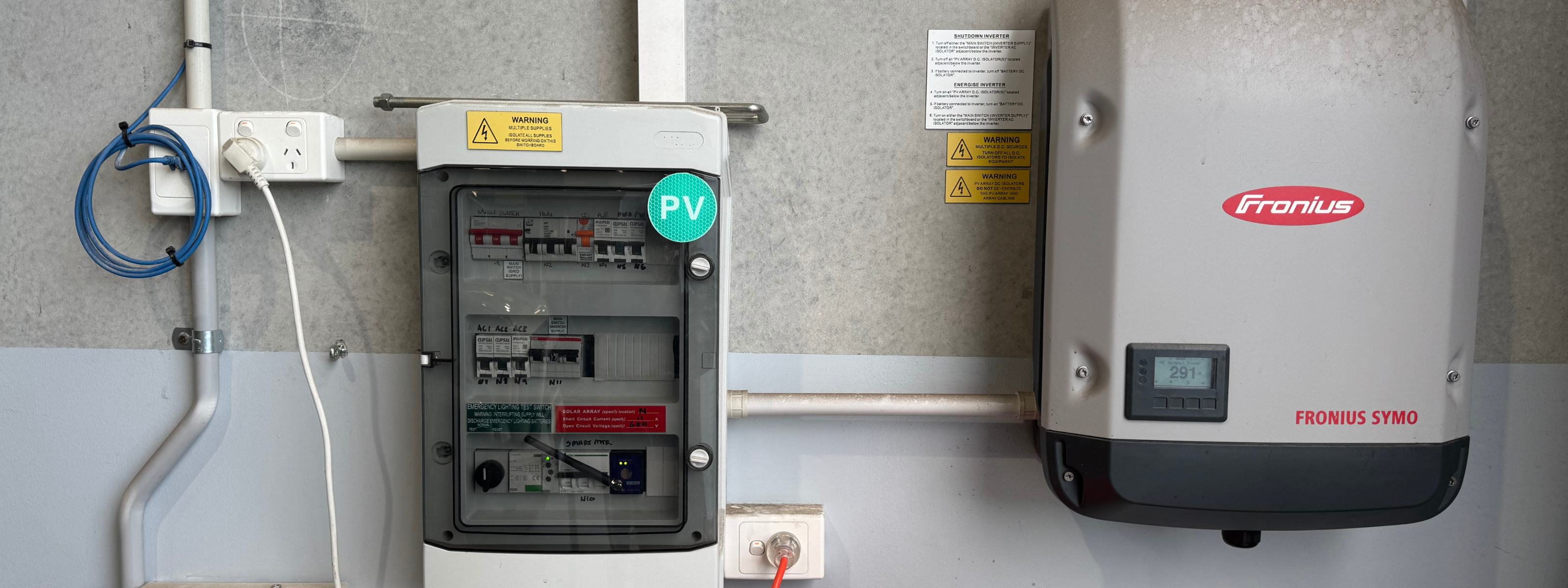 Electrical panel with Fronius equipment on a wall.