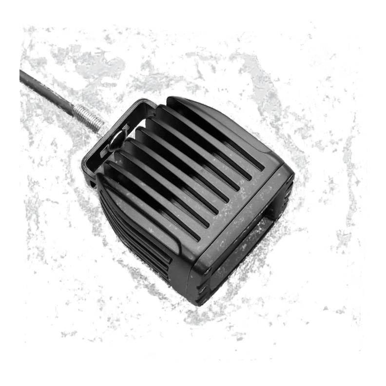 ALTIQ DX4 work light from the rear quarter, the finned heatsink filling the frame with the mounting stud and lead at the top