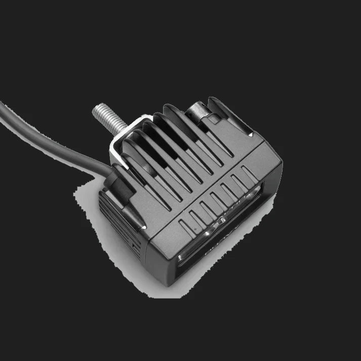 ALTIQ CX2 work light from above and behind, showing the finned cast heatsink, the threaded mounting stud and the cable leaving the rear