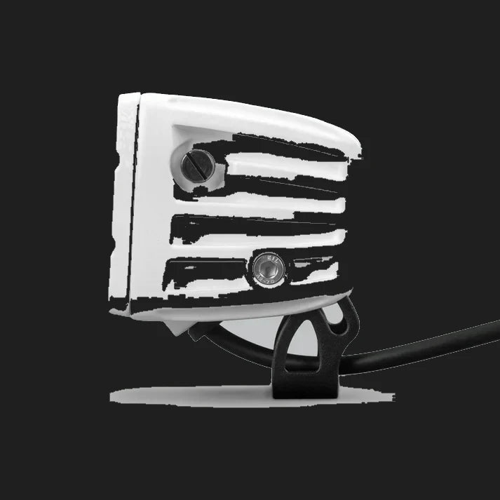White DX4 Scene work light in profile from the rear, the ribbed white housing with two adjustment screws and the black bracket beneath carrying the lead