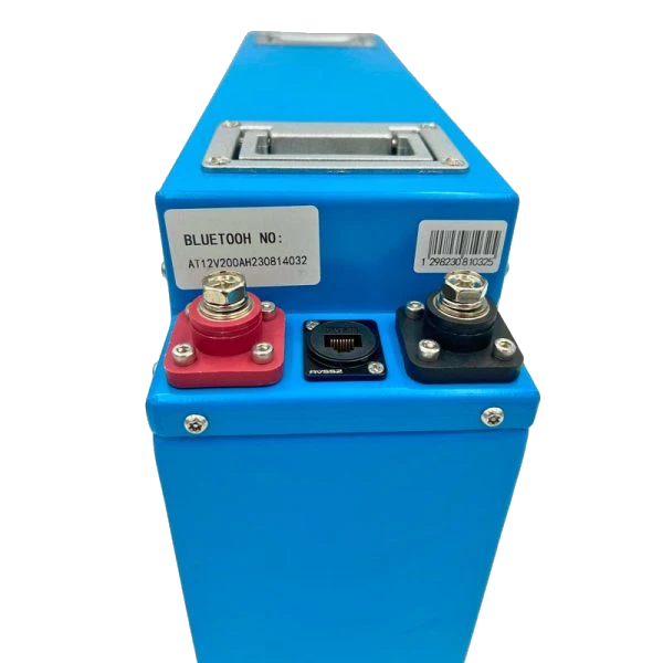 Top of the Amptron slimline lithium battery showing the recessed carry handle, the red and black terminal blocks with their stainless bolts, and the sealed communication socket between them, with the Bluetooth serial number sticker alongside