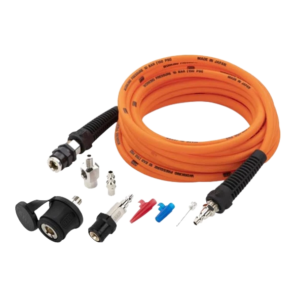 The same ARB pump up kit shown from a lower angle, the coiled orange hose behind the couplings, adaptors, deflators and chuck