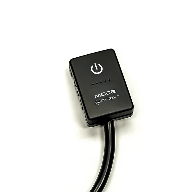Lightforce MODE touch switch seen at an angle, a black rectangular button with a power symbol, a row of five indicator dots and the MODE by Lightforce name, on a moulded body with a lead leaving the back