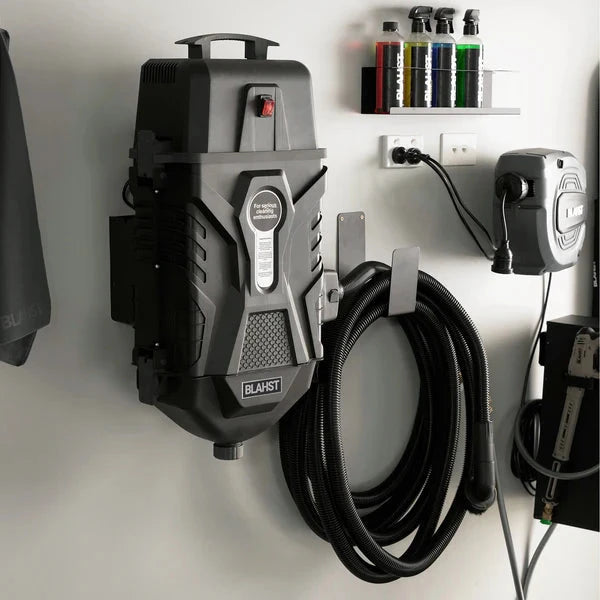 Wall-mounted Blahst K21 Vacuum in a garage setting