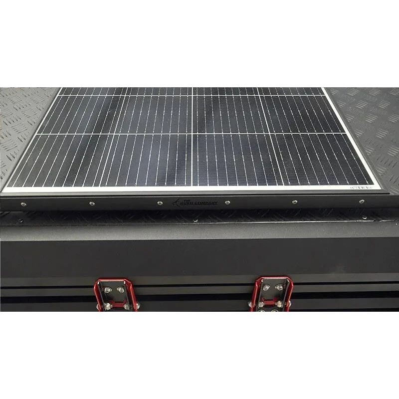 Solar panel on a bush company tent with visible brand name.