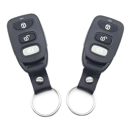 Two black remote controls with keychains on a white background