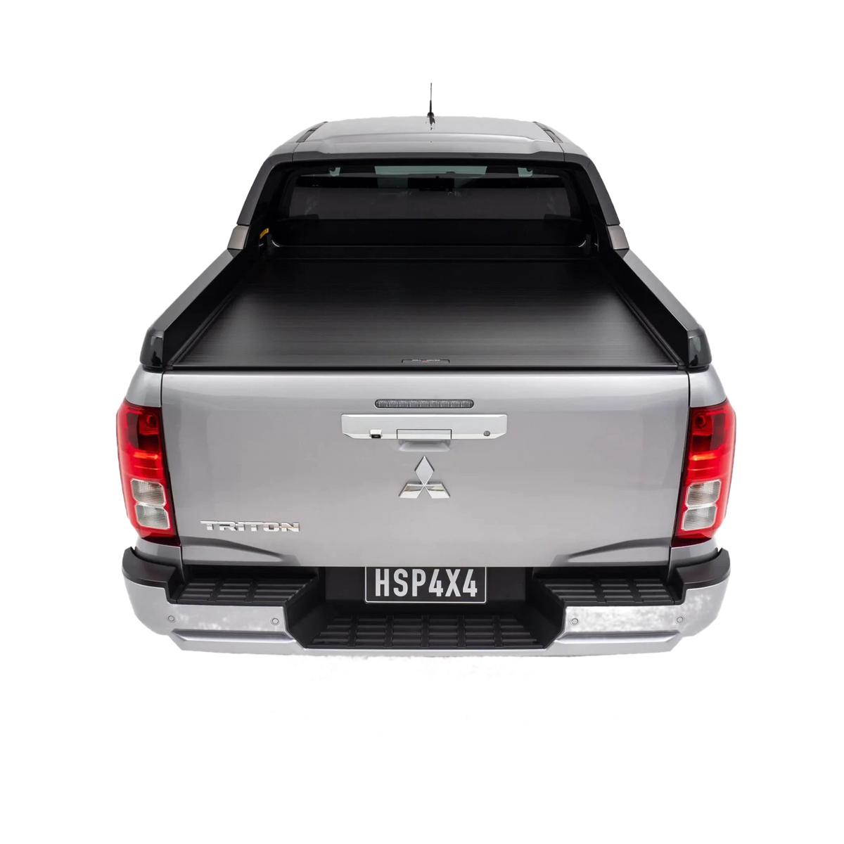 Back view of a silver Mitsubishi Triton pickup truck with a tonneau cover on a white background