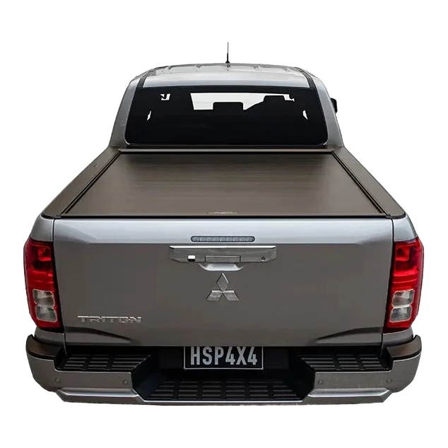Back view of a silver Mitsubishi Triton pickup truck with a tonneau cover on a white background