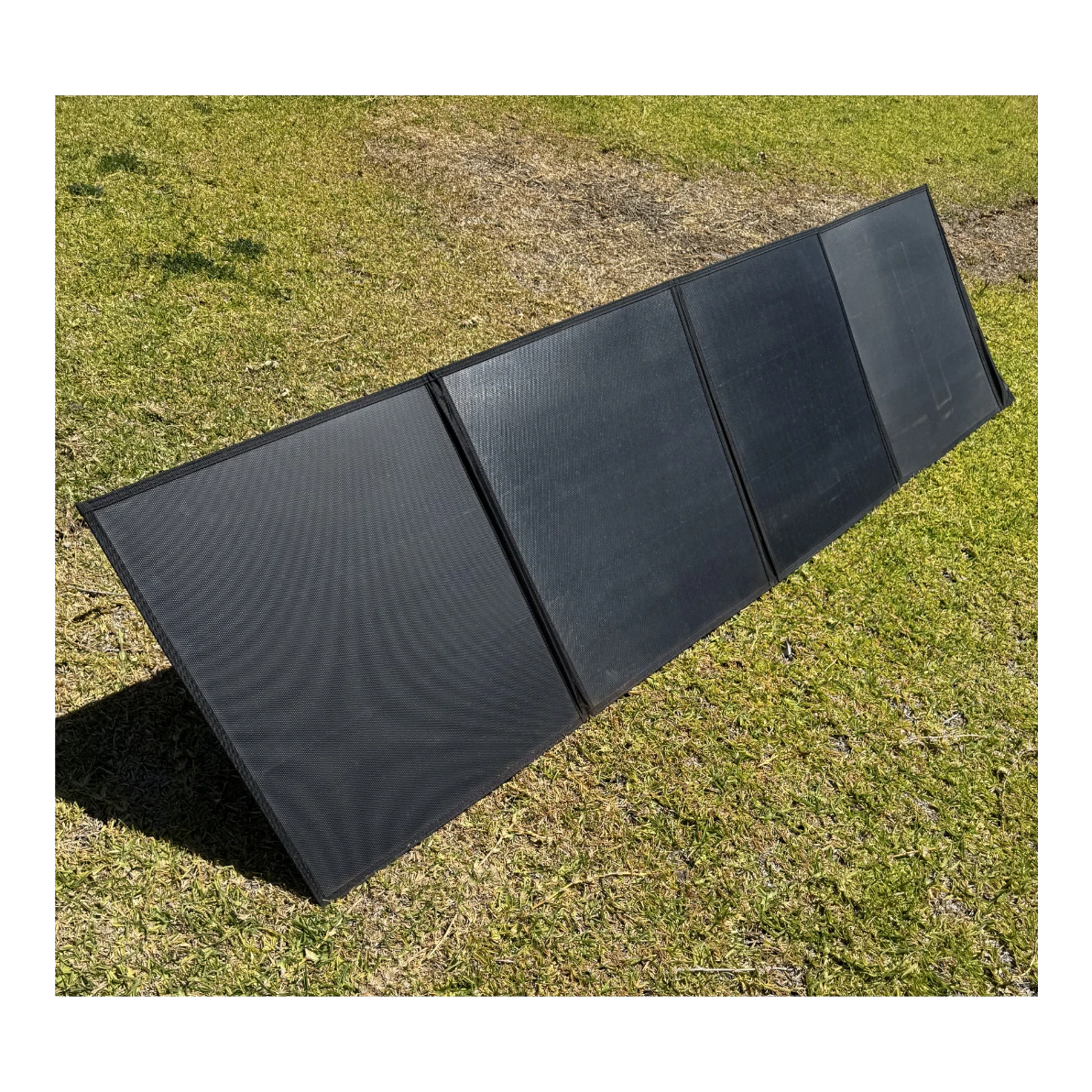 Foldable solar blanket laid out on grass – Elevate Automotive 200W 50V Solar Blanket