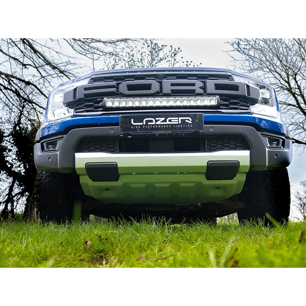 Ford Ranger Raptor (2023+) Grille Kit – front view of a Ford ute with Lazer performance lighting system on a grassy area.