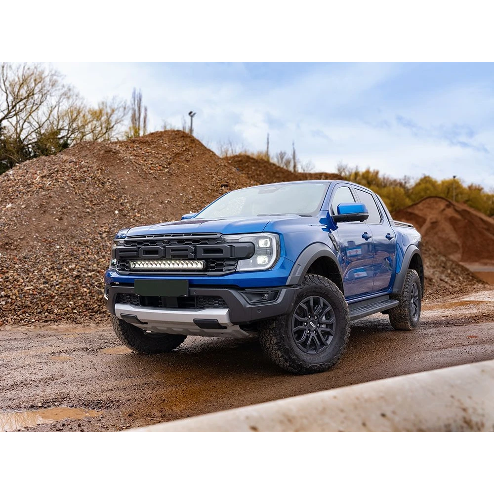 Ford Ranger Raptor (2023+) Grille Kit – blue Ford ute on a dirt road with a clear sky