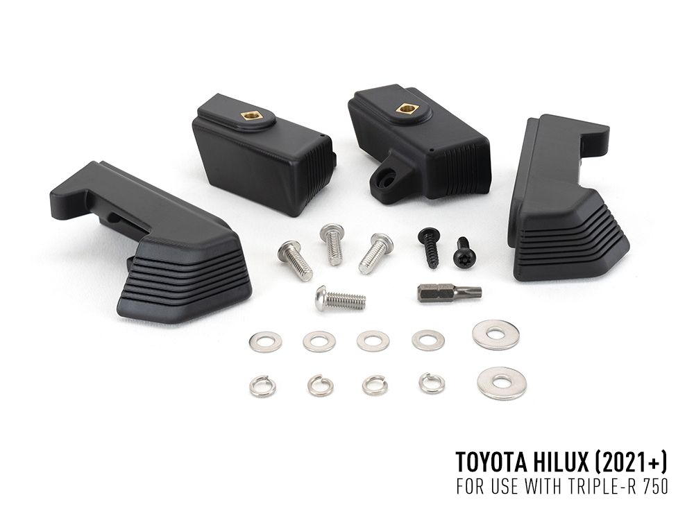 Black mechanical parts and screws on a white background with Toyota Hilux 2021+ text.
