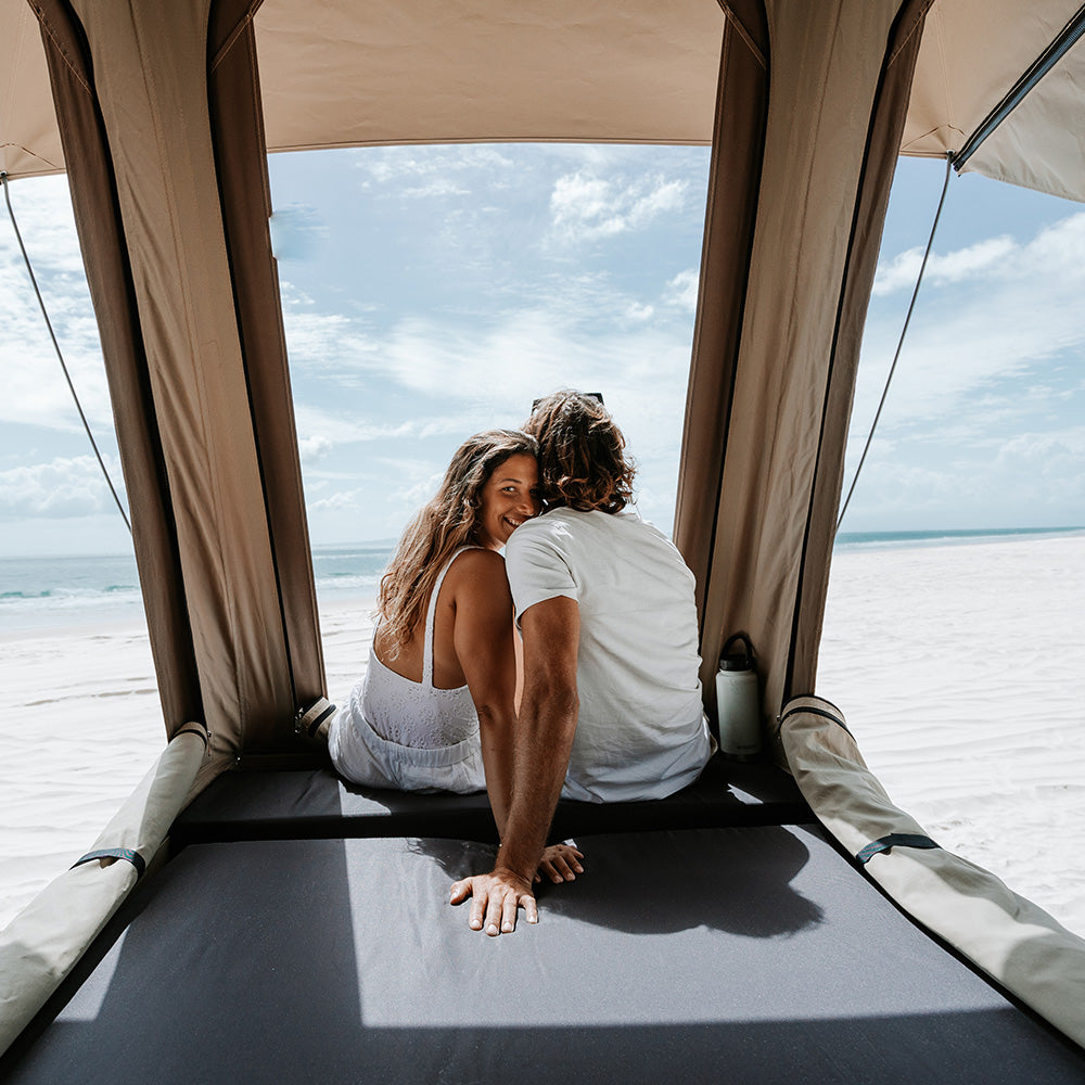 View from the bed in the raised Headspace roof of a Troopy, looking out to the beach