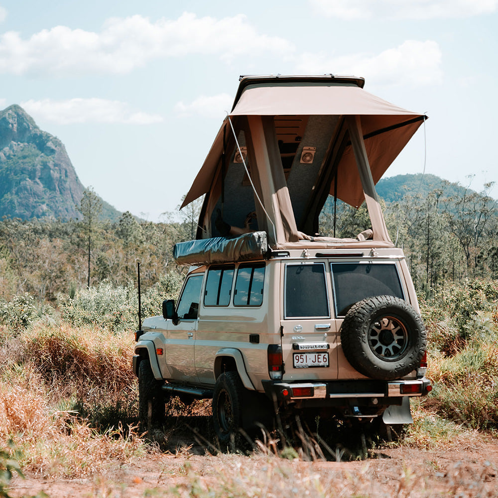 78 Series Troopy with the Headspace roof raised in a mountain landscape