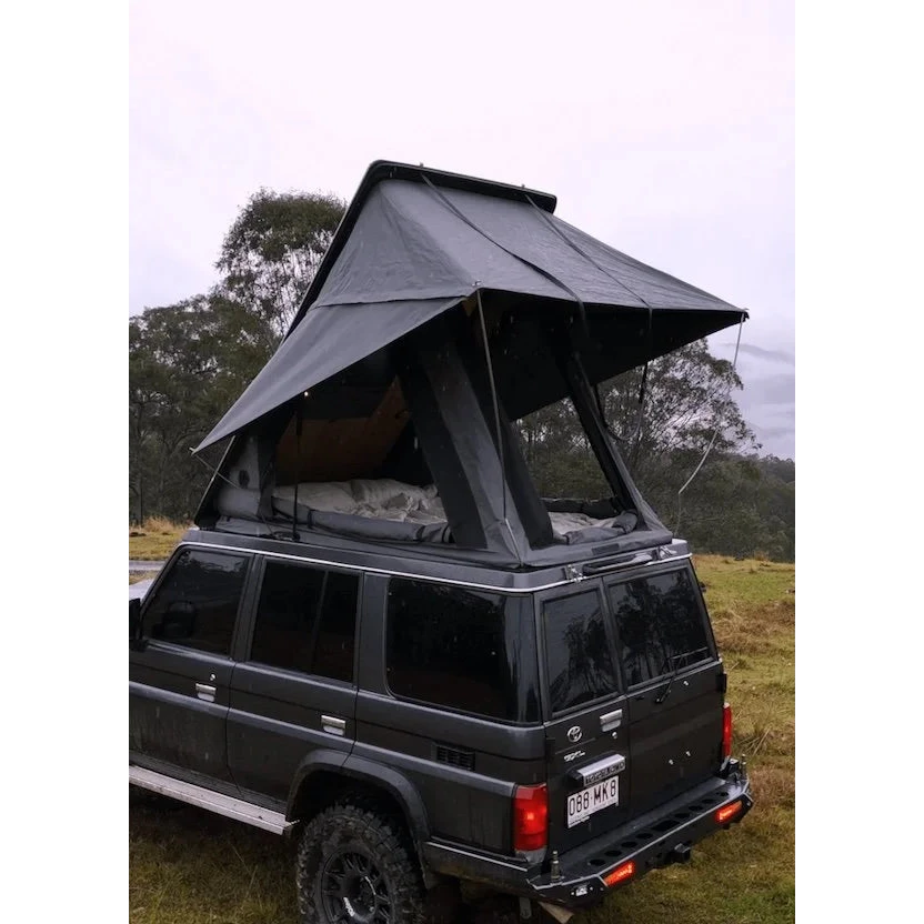 Black SUV with a rooftop tent in a natural setting – Headspace Roof Conversion LC76