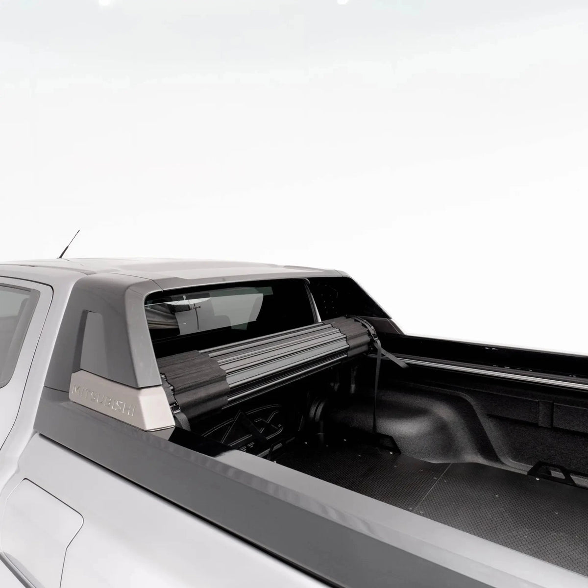 Close-up of a truck bed with a tonneau cover on a white background – HSP Roll Mate Mitsubishi Triton MV