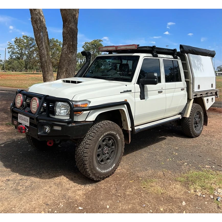 White off-road vehicle with black accents on a dirt road – Landcruiser 70-79 Series MSA POWER FOLD Towing Mirrors
