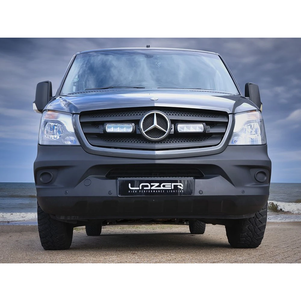 Mercedes-Benz truck with 'Lazer' branding on a beach