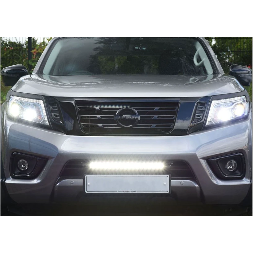Front view of a silver Nissan vehicle with headlights on with Lazer Lamps Nissan Navara (2014-2021) Kit