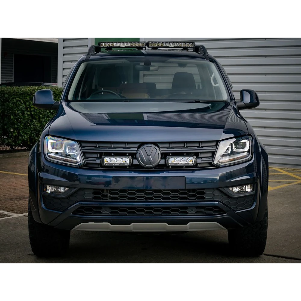 Front view of a black Volkswagen SUV with visible logo in a parking lot with Lazer Lamps Grille Kit for VW Amarok V6 (2016–2022)