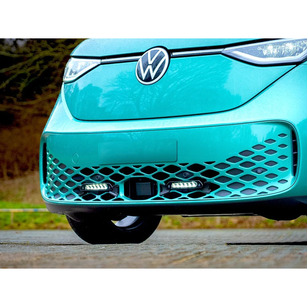 Close-up of a turquoise Volkswagen car with a blurred natural background