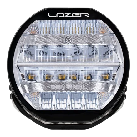 A black 7-inch Lazerlamps Sentinel LED driving light with a clear polycarbonate lens, designed for vehicles or tight mounting setups, featuring advanced LED technology.