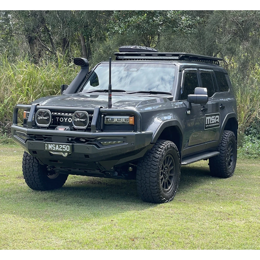 Gray Toyota prado 250 with off-road equipment on a grassy area