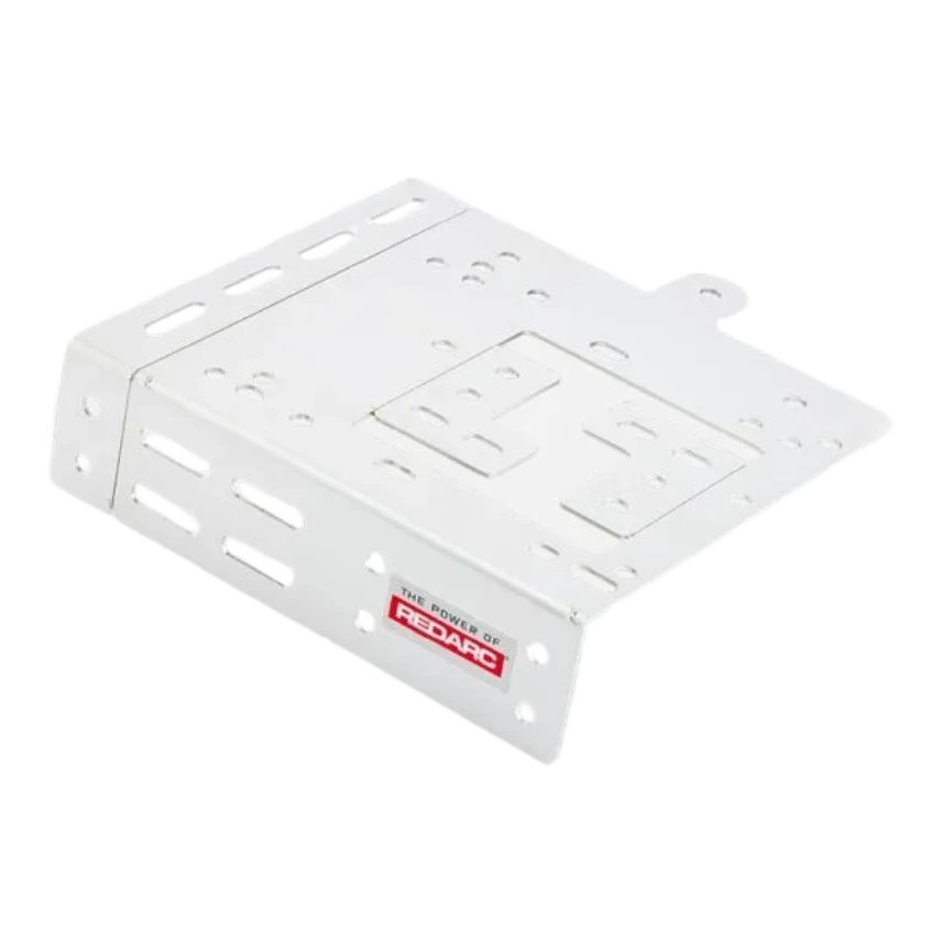White Redarc mounting bracket seen from above, a flat plate with slotted and round fixing holes, a raised centre section and turned-down edges at each end