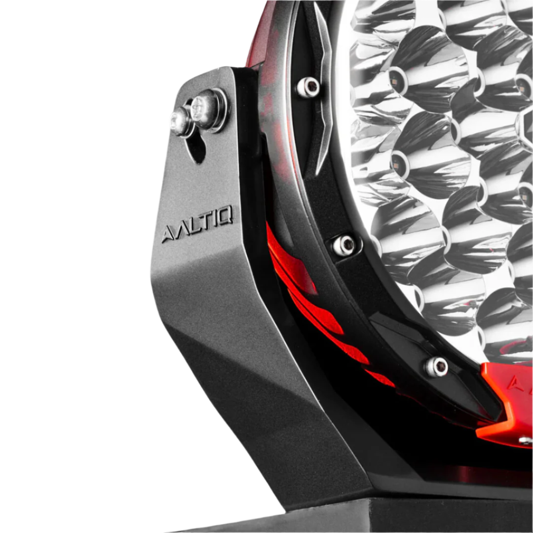 Close-up of the Rogue 8.5 mounting bracket with the ALTIQ name moulded into it, the stainless pivot bolt through the slot, and the chrome reflector cups of the lens visible alongside