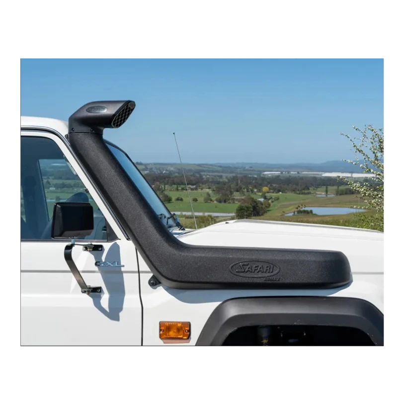 Safari snorkel fitted to a white LandCruiser 70 Series, running up the passenger side of the windscreen to a raised air ram, photographed against farmland and a clear sky