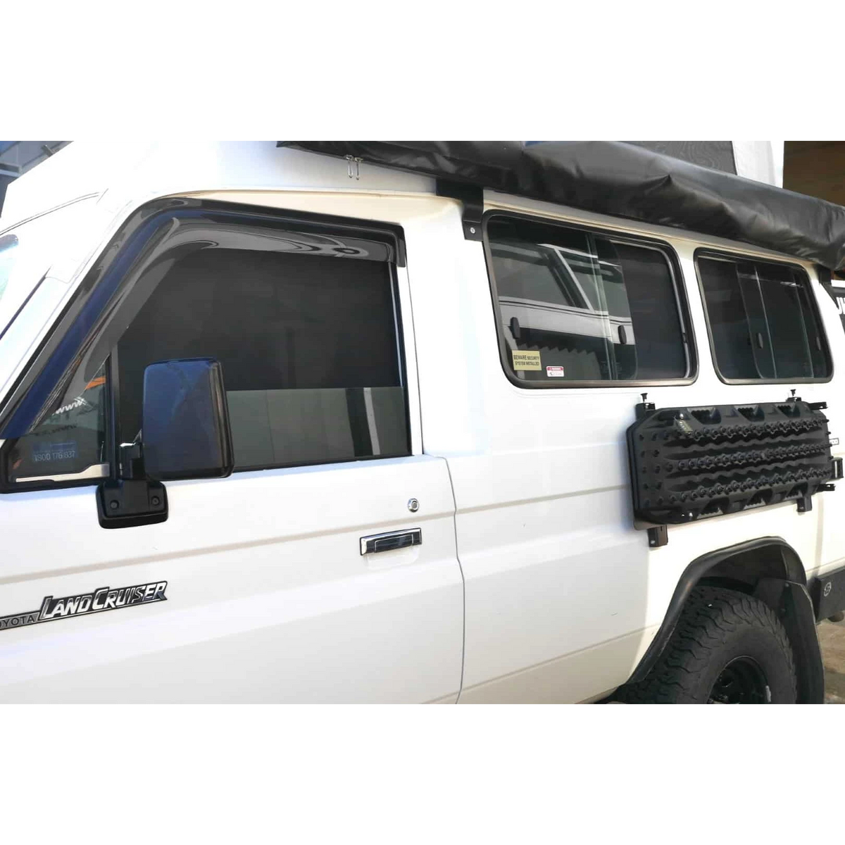 White Landcruiser Troopcarrier with roof rack and SnapShades on the side windows