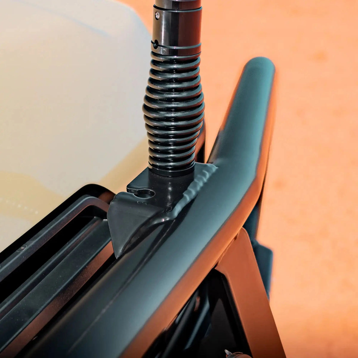 Close-up of a black metal spring and rod on a blurred background – TCC 70 Series Bull Bar - Facelift (2024 - Present)