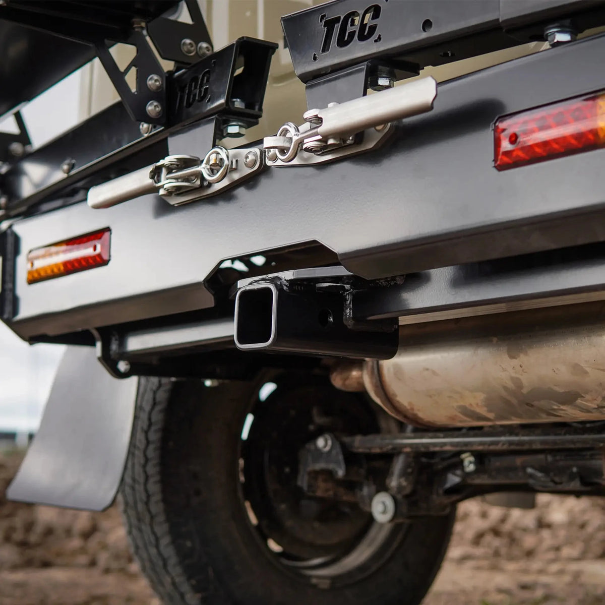 Close-up of a vehicle's hitch and trailer attachment system with 'TCC' branding – TCC Suzuki Jimny (JB74) Rear Bar